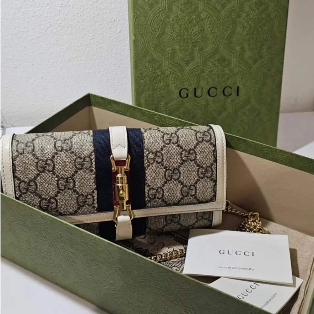 Gucci Beige and Black Clutch with Gold Accents - Picture 1 of 5